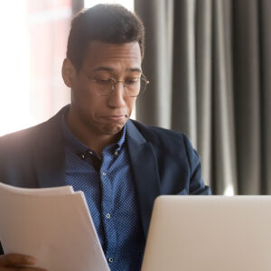 man pleasantly working on his finances