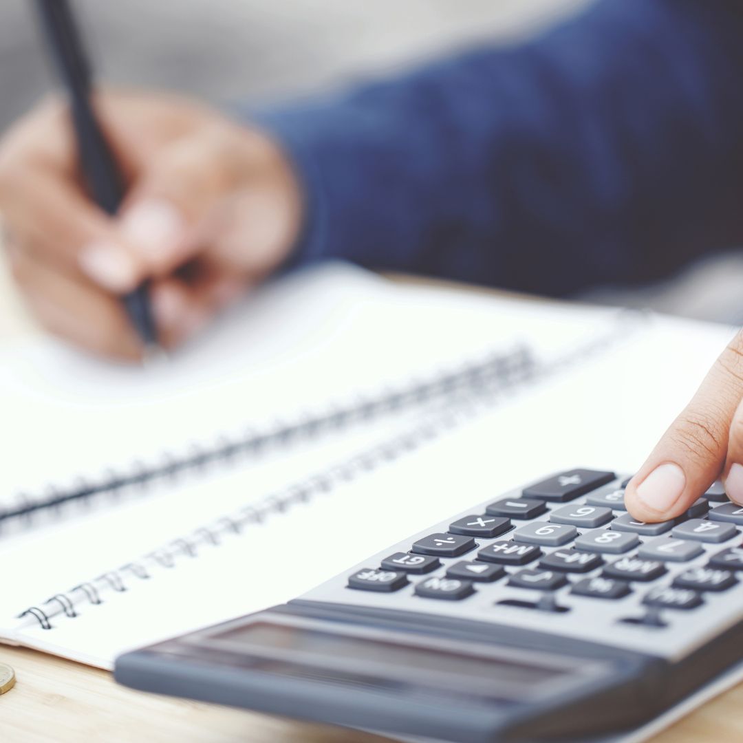 person doing taxes with calculator