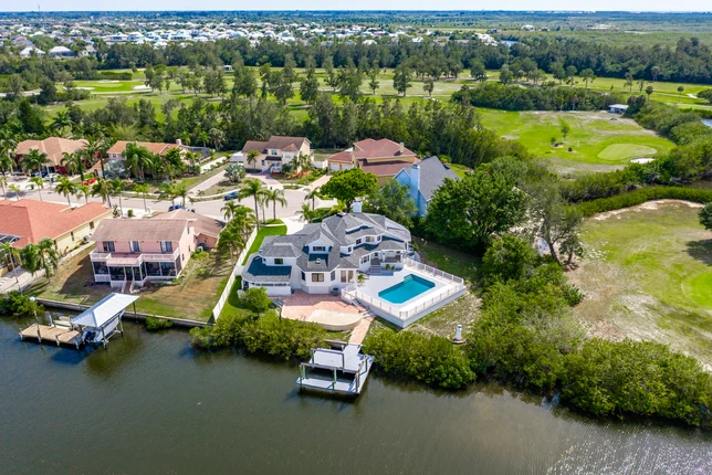 overview of luxury house with pool and water dock access