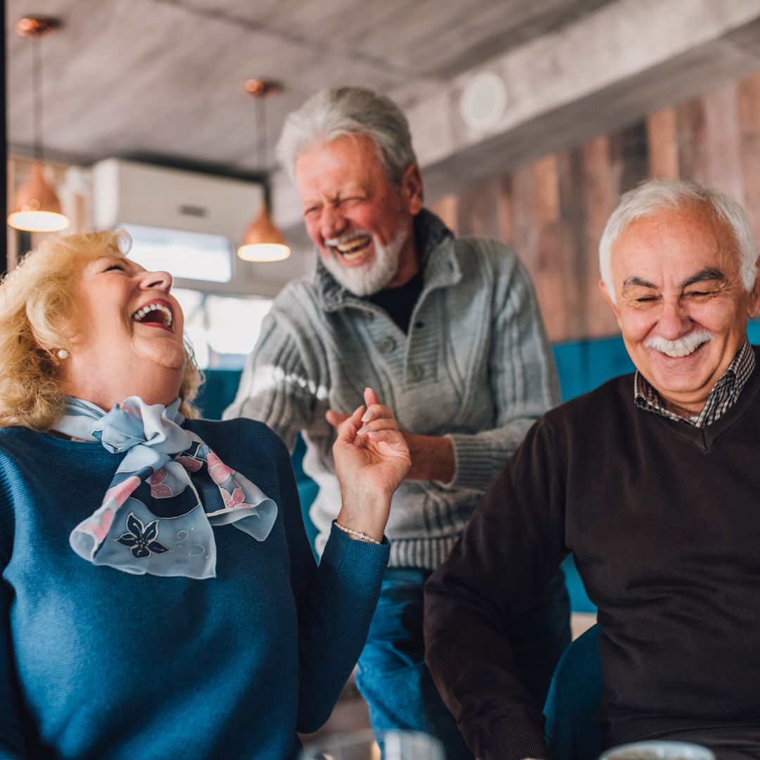 older couple laughing while seated