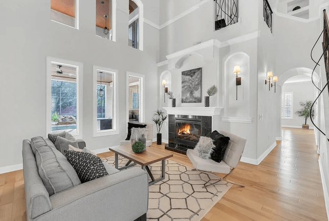 living room with high ceilings and two story windows