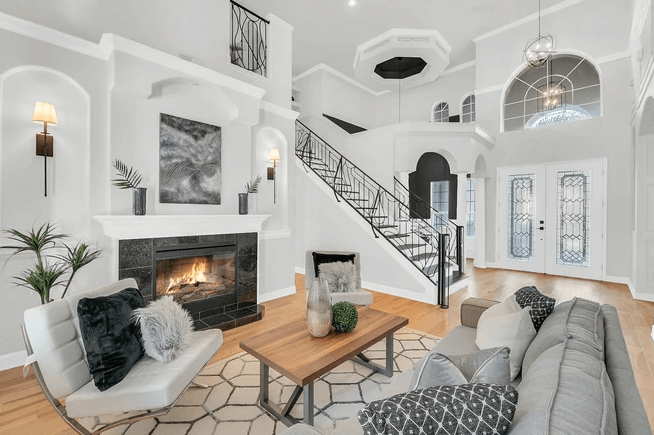 living room with elaborate staircase and high ceilings