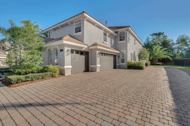 house with paver driveway
