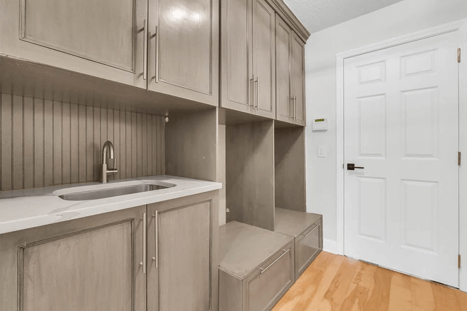 mudroom with built in cabinets and shoe cubbies