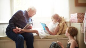 grandmother sitting on bench with kid reading