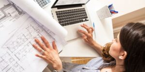 woman plans a investing development project with architectural plans