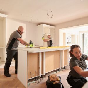 crew works on kitchen renovation with new cabinets