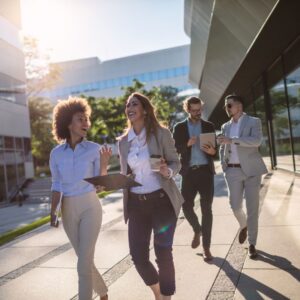 professional team walks together outside commercial buildings
