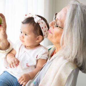 grey haired woman holds baby 