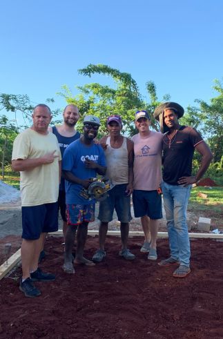 group of locals and volunteers on build site