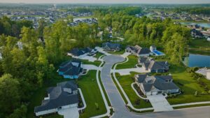 aerial view of a cul de sac with large homes and trees around