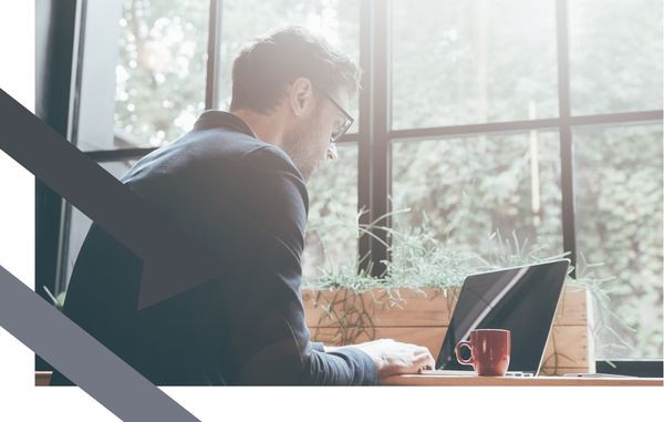 man sits in front of laptop
