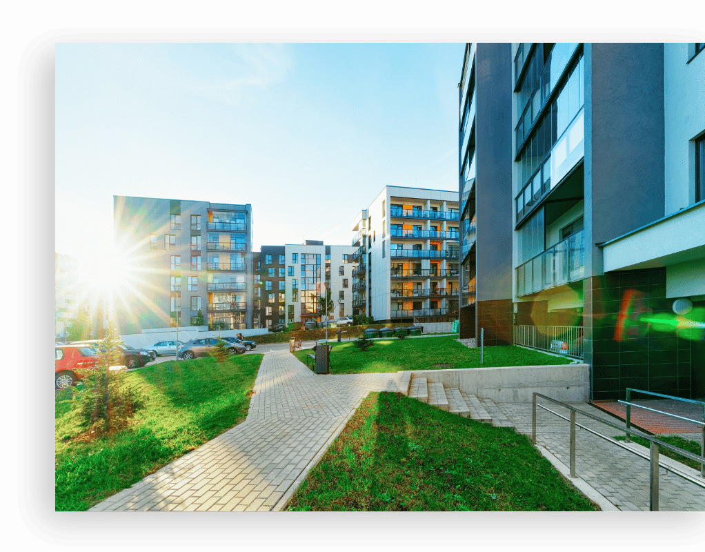 several multiple story buildings with sun shining between them