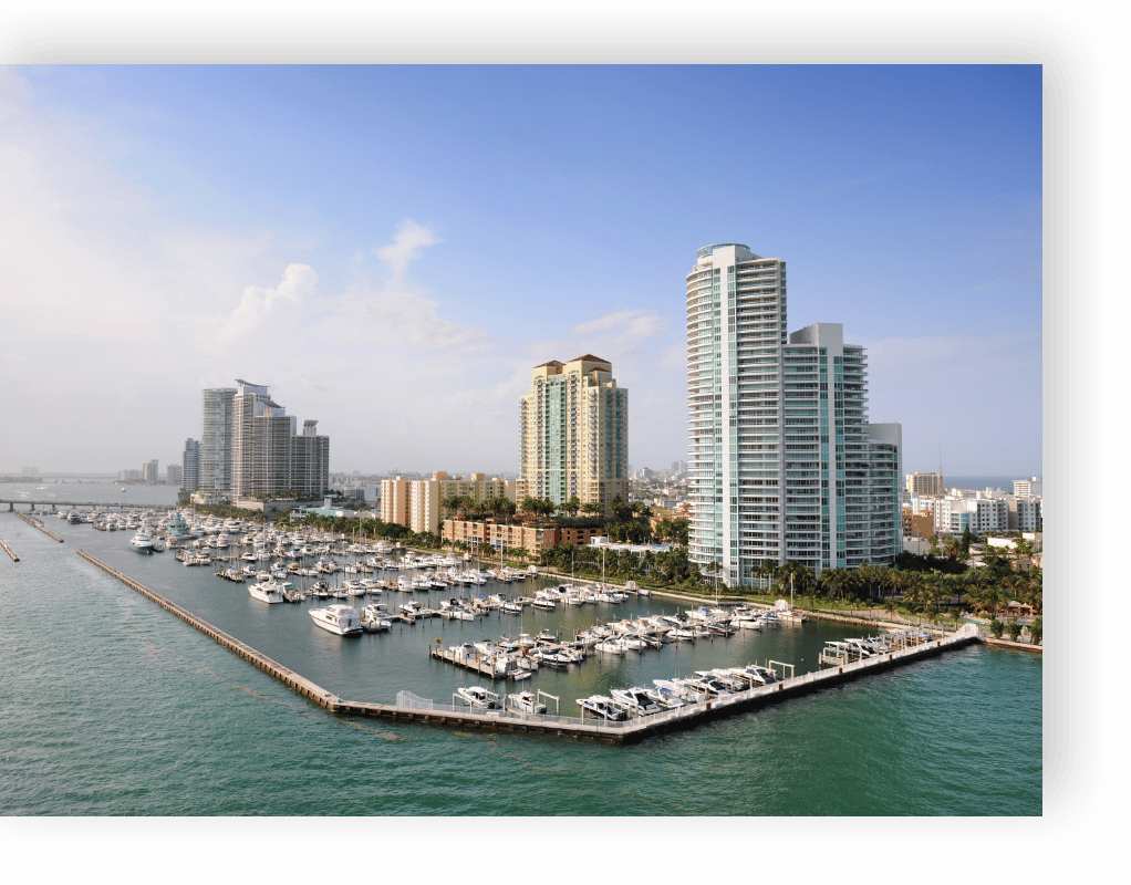 areal view of buildings and boat marina on the coast